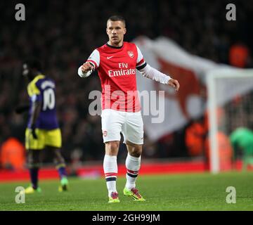 Lukas Podolski, d'Arsenal, célèbre son but d'ouverture lors du match de la Barclays Premier League entre Arsenal et Swansea City qui s'est tenu au stade Emirates de Londres, en Angleterre, le mardi 25 mars 2014. Pic David . Banque D'Images