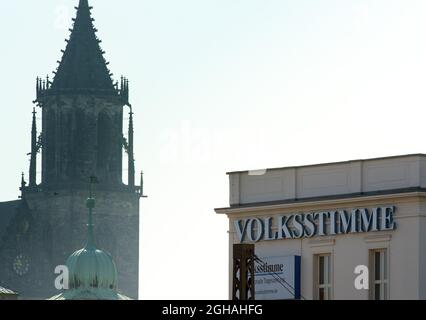 Magdebourg, Allemagne. 06e septembre 2021. Le lettrage 'Volksstimme' se trouve sur la façade d'une maison au centre-ville, debout sur fond de la cathédrale. Credit: Soeren Stache/dpa-Zentralbild/dpa/Alay Live News Banque D'Images