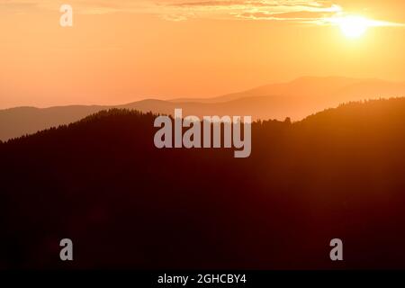 Coucher de soleil majestueux dans le paysage des montagnes avec des poutres ensoleillées Banque D'Images