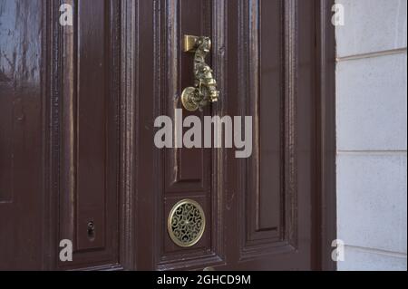 détail d'une vieille porte avec un porte-clé en métal et un péephole en métal Banque D'Images