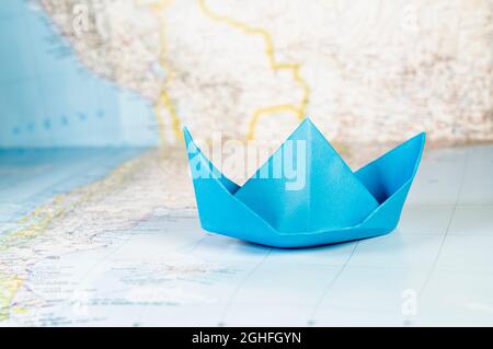 Beau bateau à papier bleu sur la carte du monde , Banque D'Images