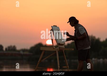 Man painting in park Banque D'Images