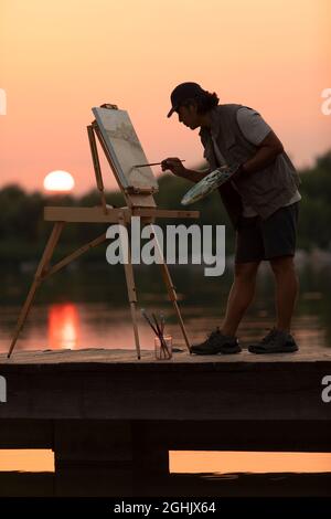 Man painting in park Banque D'Images