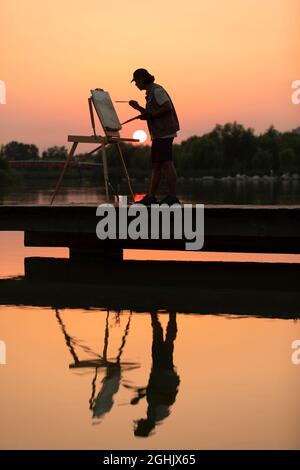 Man painting in park Banque D'Images