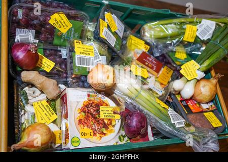 Sélection de produits alimentaires de supermarché avec des autocollants jaunes réduits en raison de leur courte durée de conservation, obsolètes. Banque D'Images