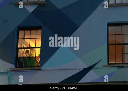 Vue d'un homme jouant de la musique depuis la fenêtre la nuit Banque D'Images