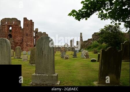 Vue extérieure sur les ruines d'un édifice prieuré médiéval de l'île de Lindisfarne dans le Northumberland. Banque D'Images