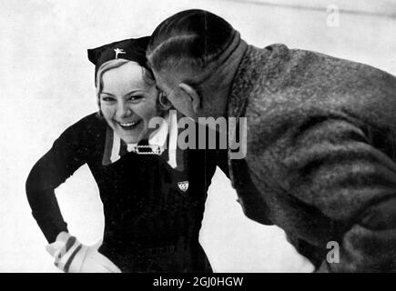 1936 Jeux Olympiques d'hiver Garmisch - Partenkirchen, Allemagne Sonja Heine, de Norvège, qui a remporté sa troisième médaille d'or aux jeux Olympiques consécutifs pour l'épreuve individuelle de patinage artistique féminin. Photo avec l'entraîneur Artur Vieregg ©TopFoto Banque D'Images