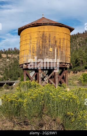 Ancienne tour d'eau en bois jaune pour le chemin de fer historique de Denver et du Rio Grande Western Railroad (D&RGW) à Dulce, Nouveau-Mexique. Banque D'Images