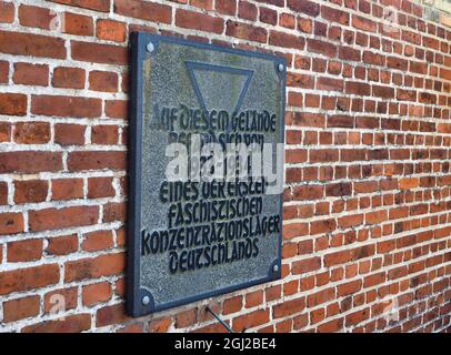 08 septembre 2021, Brandebourg, Oranienburg: Une plaque portant l'inscription 'l'un des premiers camps de concentration fasciste d'Allemagne a été situé sur ce site de 1933 à 1934' est apposée sur un mur de briques sur la Berliner Straße. En mars 1933, la sa locale avait établi le premier camp de concentration de Prusse dans l'ancienne brasserie Kindl. Jusqu'à la fermeture du camp en juillet 1934, environ 3000 prisonniers d'Oranienburg et des environs ainsi que de Berlin ont été internés ici. Au moins 16 des prisonniers sont morts dans le camp de concentration d'Oranienburg, dont l'écrivain Erich Mühsam. Le site commémoratif est Banque D'Images