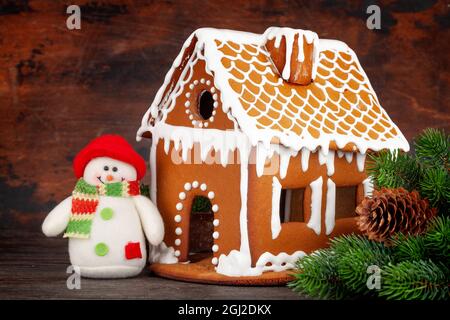 Carte de vœux de Noël avec maison en pain d'épice, sapin et bonhomme de neige Banque D'Images