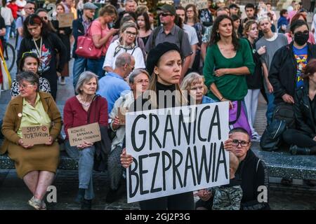 Cracovie, Pologne. 3 septembre 2021. Les manifestants tiennent des pancartes exprimant leur opinion pendant la manifestation.les manifestants ont manifesté contre l'introduction de l'état d'urgence sur la frontière biélorusse polonaise, sur la place principale inscrite au patrimoine mondial de l'UNESCO à Cracovie. Le gouvernement de la Pologne a instauré un état d'urgence dans deux régions limitrophes de la Biélorussie alors qu'un afflux de migrants du Moyen-Orient se produit. Pendant ce temps, plus de 30 000 personnes en provenance d'Afghanistan ont été coincées pendant plus de trois semaines entre les gardes biélorusses armés d'un côté et les forces polonaises armées de l'autre. Certains sont malades comme le Banque D'Images