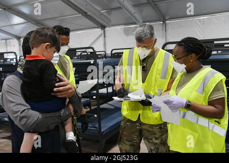 Les membres de la Force aérienne des États-Unis et de la Garde nationale aérienne aident une famille afghane à trouver des logements temporaires à leur arrivée au village Liberty, base conjointe McGuire-dix-Lakehurst, New Jersey, le 7 septembre 2021, à l'appui de l'opération alliés Bienvenue. dirigée par le ministère d'État Le ministère de la Défense, par l'intermédiaire du Commandement du Nord des États-Unis, et en appui au ministère de la sécurité intérieure, fournit le transport, le logement temporaire, le dépistage médical et le soutien général à au moins 50,000 personnes évacuées afghanes dans des installations appropriées, dans des structures permanentes ou temporaires, le plus rapidement possible. Cette init Banque D'Images