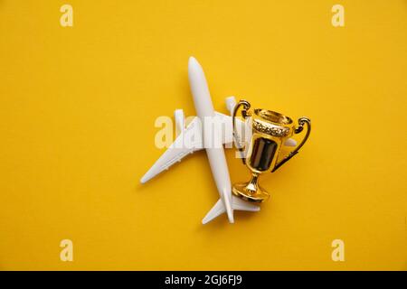 Voyages en avion. Satisfaction de l'industrie aéronautique. Jouet avion avec trophée d'or Banque D'Images