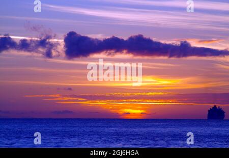 Coucher de soleil sur l'océan Atlantique avec bateau de croisière à Sint Maarten. Banque D'Images