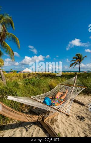 Relaxing in hammock on Grace Bay Beach, Providenciales, Turks et Caicos, Caraïbes. (MR) Banque D'Images