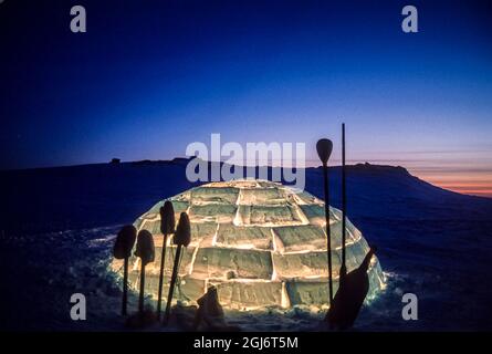 Baker Lake, Nunavut, Canada. Des outils inuits ont été détourés contre un igloo éclairé au crépuscule. Banque D'Images