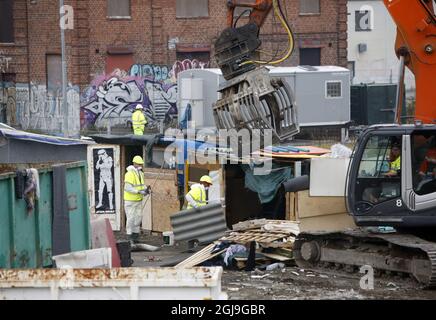 Un excavateur et du personnel de démolition nettoient un camp illégal dans le centre de Malmoe, en Suède, le 3 novembre 2015. La police suédoise a commencé à nettoyer un camp de Roms dans le centre de Malmö après un mois d'affrontement entre les autorités municipales et environ 200 personnes qui s'y étaient installées sans autorisation. Photo: Drago Prvulovic / TT Banque D'Images