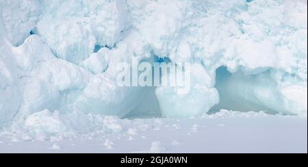 Iceberg gelé dans la glace de mer de la baie Melville, près de Kullorsuaq, à l'extrême nord de l'ouest du Groenland. Banque D'Images