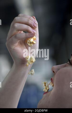 Une femme mangeant du pop-corn photo: Janerik Henriksson / TT code 10010 Banque D'Images