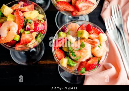 Cocktails Ceviche aux crevettes aux fraises servis dans des verres coupe : salade de crevettes servie dans une soucoupe de champagne Banque D'Images