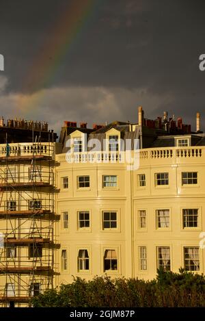 Échafaudage érigé sur les maisons de Brunswick Square, Hove East Sussex, Angleterre. Arc-en-ciel dans le ciel de moody au-dessus. Banque D'Images