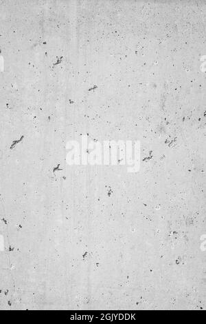 Gros plan d'un mur en ciment ou en béton avec de petits trous, vue de face. Arrière-plan texturé plein format haute résolution en noir et blanc. Copier l'espace. Banque D'Images