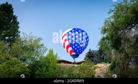 Un ballon d'air chaud flotte sur une maison Banque D'Images