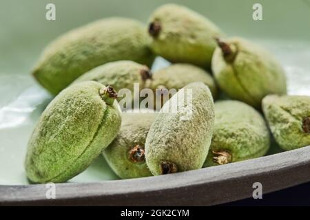 Amandes fraîches juste récoltées de l'arbre dans l'assiette avant la cuisson. Banque D'Images