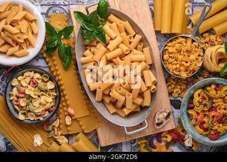 Pâtes. pâtes italiennes. Variété de pâtes italiennes traditionnelles : spaghetti colorés, tagliatelle, farfalle, penne, ptititm, nouilles, fusilli, cannelloni on Banque D'Images