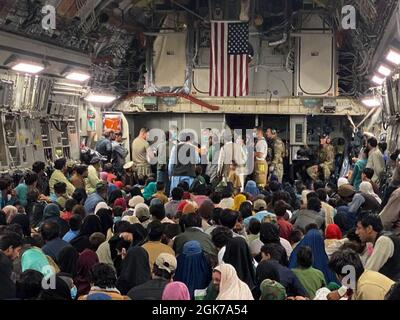 Un nouveau-né est pris en charge avant d'être retiré d'un C-17 Globemaster III, le 23 août, dans une zone de transit au Moyen-Orient. Un équipage du 315e Airlift Wing de la joint base Charleston, en Caroline du Sud, a aidé à livrer un bébé à bord d'un Charleston C-17 Globemaster III transportant des Afghans vulnérables évacués d'Afghanistan, le 23 août, quelques instants avant d'atterrir dans une zone de rassemblement du Moyen-Orient. Le capitaine Leslie Green, infirmière de vol du 375e Escadron d'évacuation aéromédicale, faisait partie de l'équipage de la mission et elle a aidé à livrer le bébé. Le 315e AW et d'autres organisations militaires américaines et alliées restent concentrés sur le Banque D'Images