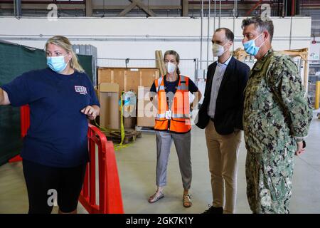 STATION NAVALE AÉRIENNE DE SIGONELLA, Italie (août 27, 2021) – de gauche à droite, un volontaire de l'USO présente une aire de jeu pour enfants à Kimberly Krhounek, ministre politique Conseiller, ambassade des États-Unis à Rome, Thomas Smitham, chargé d'affaires ambassade des États-Unis à Rome, et au capitaine Kepper Pickard, commandant de la base aérienne navale de Sigonella, dans un centre de traitement pour personnes évacuées à NAS Sigonella, le 27 août 2021. NAS Sigonella appuie actuellement la mission du département d'État visant à faciliter le départ et la réinstallation en toute sécurité des citoyens américains, des bénéficiaires de visas d'immigration spéciaux et des populations vulnérables d'Afghanistan. Banque D'Images