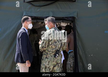 STATION NAVALE AÉRIENNE DE SIGONELLA, Italie (août 27, 2021) – Thomas Smitham, chargé d'affaires ambassade des États-Unis à Rome, à gauche, écoute le capitaine Kepper Pickard, commandant de la base aérienne navale de Sigonella, explique le processus de réception des évacués à NAS Sigonella, le 27 août 2021. NAS Sigonella appuie actuellement la mission du département d'État visant à faciliter le départ et la réinstallation en toute sécurité des citoyens américains, des bénéficiaires de visas d'immigration spéciaux et des populations vulnérables d'Afghanistan. Banque D'Images