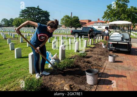 Kassandra Livingston, technicien en systèmes d'information de première classe, de Rochester, New York, plante de nouvelles fleurs lors d'un événement bénévole du CRMD au Hampton National Cemetery Complex, à Hampton, Virginie, le 28 août 2021. John C. Sennis est à Newport News Shipyard travaillant aux côtés de NNS, de NAVSEA et d'entrepreneurs qui effectuent le ravitaillement en carburant et la révision complexe dans le cadre de la mission de livrer le navire de guerre dans le combat, dans les délais et dans le budget, pour reprendre son devoir de défendre les États-Unis. Banque D'Images