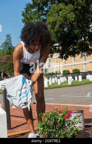 Le Matelot de 1re classe Jada Chepkwurui, technicien en systèmes d'information, de St. George, Utah, répand du sol autour des fleurs nouvellement plantées lors d'un événement bénévole de la CRMD de l'USS John C. Stennis (CVN 74) au complexe du cimetière national de Hampton, à Hampton, en Virginie, le 28 août 2021. John C. Sennis est à Newport News Shipyard travaillant aux côtés de NNS, de NAVSEA et d'entrepreneurs qui effectuent le ravitaillement en carburant et la révision complexe dans le cadre de la mission de livrer le navire de guerre dans le combat, dans les délais et dans le budget, pour reprendre son devoir de défendre les États-Unis. Banque D'Images