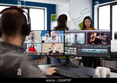 Chef de projet en web réunion en ligne avec l'équipe sur vidéo appel montage créatif client, obtenir des commentaires sur le projet de film en utilisant le logiciel de post-production sur l'ordinateur dans le bureau de démarrage Banque D'Images