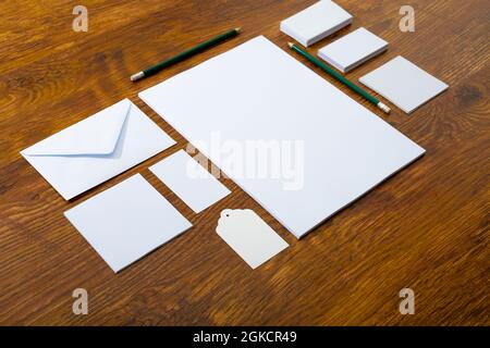 Composition de cartes blanches et d'enveloppes avec crayons sur fond de bois Banque D'Images