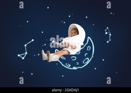 Œuvres d'art créatives de petite fille mignonne prétendant être astronaute isolé sur fond bleu foncé avec des dessins d'espace blancs. Banque D'Images