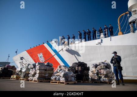 L'équipage du Cutter Munro de la Garde côtière se réunit en formation derrière la contrebande saisie lors d'un déchargement de drogue à Alameda, en Californie, le 23 mars 2021. Munro est l'un des quatre Cutters de sécurité nationale qui ont été domiciliés à Alameda. Ces découpeuses de la classe Legend ont une longueur de 418 pieds, une largeur de 54 pieds et un déplacement de 4,600 tonnes. Ils ont une vitesse maximale de plus de 28 noeuds, une plage de 12,000 milles marins, une endurance jusqu'à 90 jours et peuvent tenir un équipage de près de 150. Banque D'Images