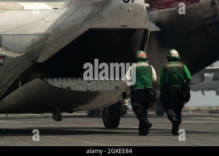 OCÉAN INDIEN (30 mars 2021) – U.S. Navy Aviation Structural Mechanic 2e classe Jay Gleeson, de Denver, à gauche, Et Adrian McCree, de la Marine américaine, d’Atlanta, suit un Greyhound C-2A, affecté aux “fournisseurs” de l’escadron de soutien logistique de la flotte (VRC) 30, sur le pont de vol du porte-avions USS Theodore Roosevelt (CVN 71) le 30 mars 2021. Le groupe de grève des transporteurs Theodore Roosevelt est en cours de déploiement prévu dans la zone d'exploitation de la 7e flotte des États-Unis. En tant que plus grande flotte déployée à l’avant de la Marine américaine, la 7e flotte opère et interagit régulièrement avec 35 nations maritimes tout en se comportant Banque D'Images