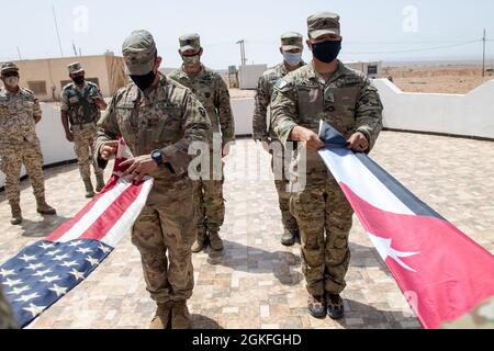 Forces armées jordaniennes, Commandement Sud, 3e commandant du Groupe des gardes-frontières, Col. Ra'ad Al Aamayra, Et la Force opérationnelle Division Spartan tactique- officier de Jordanie responsable, le colonel Christopher Fletcher, échange des drapeaux dans un geste symbolique d'amitié et de partenariat après l'achèvement réussi de l'exercice de tir en direct Desert Warrior 21, le 8 avril 2021. L'exercice a été vu par les officiers généraux du JAF et les hauts dirigeants du centre de l'Armée des États-Unis et de la FO Spartan. Les moments de gratitude exprimée aident à solidifier la relation durable entre les deux forces. Banque D'Images