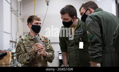 Le capitaine Samuel Shrewsberry, au milieu, et le capitaine Michael McBrien, à droite, au 340e Escadron d'entraînement d'armes, étudiants en cours d'instructeur d'armes, reçoivent des instructions de l'ancien Airman Chad McCannon, à gauche, 548e Escadron d'entraînement de combat, au cours d'un entraînement à la construction de bombes à la base aérienne de Barksdale, en Louisiane, le 13 avril 2021. Les aviateurs assistent au 33ème WPS afin de s'entraîner à devenir des instructeurs d'armes certifiés. Banque D'Images