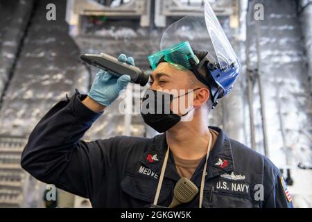 OCÉAN PACIFIQUE (18 avril 2021) le compagnon d'électricien de 1re classe Christopher Medve de Wadsworth, Ohio, utilise un réfractomètre à bord du navire de combat littoral de type Independence-variant USS Charleston (LCS 18), avril 18. Charleston est actuellement en activité dans la troisième flotte des États-Unis. Banque D'Images