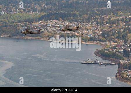 Les soldats de l'aviation de l'armée américaine, affectés au 1er-229e Bataillon de reconnaissance d'attaque, 16e Brigade de l'aviation de combat, effectuent un exercice de préparation au déploiement d'urgence pour démontrer les capacités des nouveaux hélicoptères Apache AH-64E version 6 (V6) sur la base interarmées Lewis-McChord, Washington, le 22 avril 2021. Le bataillon du requin tigre est la première unité opérationnelle de l’Armée à recevoir la V6, l’hélicoptère de combat le plus avancé à ce jour. Banque D'Images