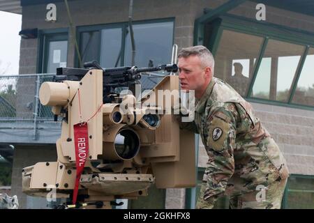 Sergent de la réserve de l'armée Corbin Rud, policier militaire de la 79e compagnie MP, emprunte une mitrailleuse à distance M-240 de la station d'armes commune lors d'un entraînement à fort McCoy, Wisc., le 23 avril 2021. Avant que les armes puissent être correctement tirées, ils doivent être borigés. Banque D'Images