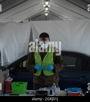 L'officier américain Sailor Petty de 3e classe Thomas Kriss, 1er Bataillon médical, Charlie Company, Camp Pendleton Calif, prépare un vaccin pour administration tandis qu'un membre de la communauté arrivant est inscrit au Centre communautaire de vaccins du Centre d'affaires bon Carre à bâton Rouge, en Louisiane, le 28 avril 2021. Kriss garantit un processus de vaccination sûr, rapide et professionnel, ce qui facilite l'opération en général. Le Commandement du Nord des États-Unis, par l'entremise de l'Armée du Nord des États-Unis, demeure déterminé à fournir un soutien continu et souple du ministère de la Défense à l'Agence fédérale de gestion des urgences A. Banque D'Images