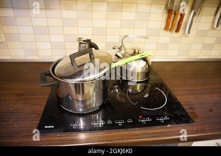 POZNAN, POLOGNE - 05 mars 2016 : gros plan d'une casserole en argent sur une plaque à induction dans la cuisine Banque D'Images