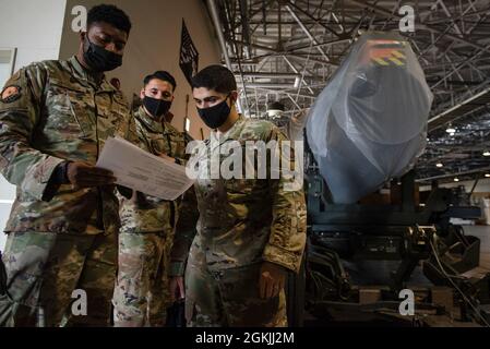 De gauche à droite, le sergent d'état-major. Donald Jackson, 730e Escadron de la mobilité aérienne, superviseur de fret, Sgt. Michael Freitas, 730e AMS artisan de la propulsion aérospatiale, et Sgt. Michael Freitas, 730ème superviseur de quart de fret aérien AMS, inspecter et préparer un moteur C-17 à charger sur un C-17 Globemaster III, le 4 mai 2021, à la base aérienne de Yokota, au Japon. Le 730ème AMS a donné le moteur aux aviateurs de la base aérienne de Kadena affectés au 733ème AMS pour améliorer leur programme de formation, permettant aux mainteneurs de naviguer dans la nomenclature et de dépanner les problèmes de moteur sur un actif réel d'avion. Trouver des moyens d'améliorer la tra Banque D'Images