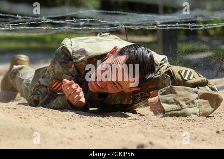 SPC. Caleb Seals, un fantassin affecté au 3e Bataillon, 15e Régiment d'infanterie, 2e équipe de combat de la Brigade blindée, 3e Division d'infanterie, Low Crawls dans le cadre d'un cours d'obstacle pendant le Soldat de la Division et officier non commissionné de l'année à fort Stewart, Géorgie, le 6 mai 2021. Seals a été l'un des 13 candidats au concours. Banque D'Images