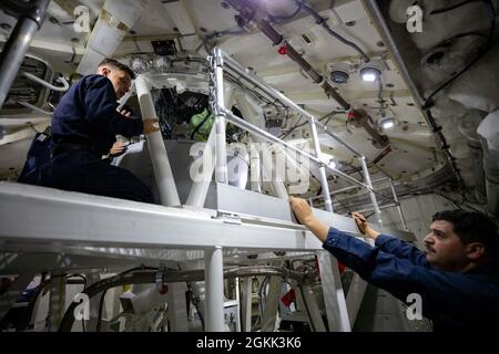 210511-N-RL695-1078 MER DES CARAÏBES - (11 mai 2021) -- le compagnon de Gunner de 3e classe Cody Harris, à gauche, et le compagnon de Gunner de 1re classe Richard Martinez, affecté au navire de combat littoral variant Freedom USS Sioux City (LCS 11), téléchargent des armes pendant que le navire se prépare à entrer au port, le 11 mai 2021. Sioux City est déployée dans la zone d’opérations de la 4e flotte des États-Unis pour appuyer la mission de la Force opérationnelle interagences conjointe Sud, qui comprend des missions de lutte contre le trafic illicite de drogues dans les Caraïbes et le Pacifique oriental. Banque D'Images
